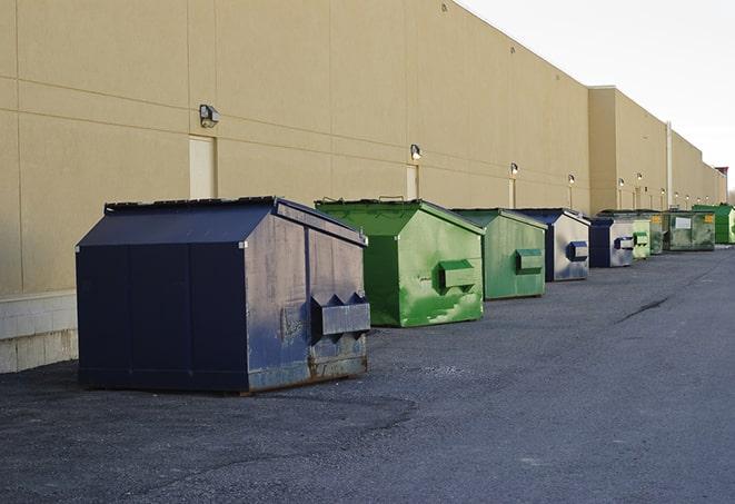 a pack of different construction bins lined up for service in Brattleboro